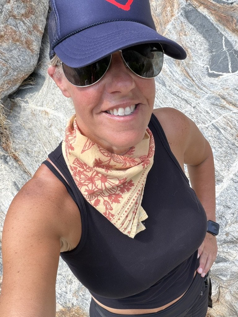 Raquel laughing with a friend on a hike